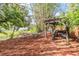 Inviting fire pit area with seating, next to a pond and bridge, offering a relaxing outdoor experience at 2779 Diane Ter, Clearwater, FL 33759