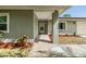 Inviting front entrance with a covered porch, lush landscaping, and stylish exterior accents at 2779 Diane Ter, Clearwater, FL 33759