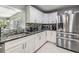 Bright kitchen with white cabinets, granite countertops, stainless steel appliances, and stylish backsplash at 2779 Diane Ter, Clearwater, FL 33759