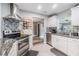 Well-equipped kitchen with modern appliances, granite countertops, custom backsplash, and ample cabinet space at 2779 Diane Ter, Clearwater, FL 33759