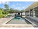 Inviting pool area with brick pavers, lounge chairs, and an outdoor swing for ultimate relaxation at 2779 Diane Ter, Clearwater, FL 33759