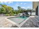 Sparkling pool with lounge chairs and a pergola, perfect for outdoor relaxation and enjoyment at 2779 Diane Ter, Clearwater, FL 33759