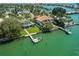 An expansive waterfront property with a private boat dock, lush greenery, and beautiful landscaping at 3 Paradise Ln, Treasure Island, FL 33706