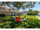 Expansive backyard with a fire pit and seating area offering peaceful water views at 3 Paradise Ln, Treasure Island, FL 33706