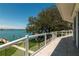 Relax on this covered balcony overlooking stunning waterfront views and a lush lawn at 3 Paradise Ln, Treasure Island, FL 33706