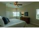 Bright bedroom with water view and wooden dresser at 3 Paradise Ln, Treasure Island, FL 33706