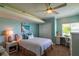 Cozy bedroom features a ceiling fan, desk space, and a large window at 3 Paradise Ln, Treasure Island, FL 33706