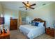 Spacious bedroom features wooden furnishings, ceiling fan, and tranquil ambiance at 3 Paradise Ln, Treasure Island, FL 33706