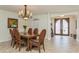Inviting dining room with natural light, chandelier, and adjacent entry at 3 Paradise Ln, Treasure Island, FL 33706