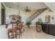 Open foyer with a staircase, bar seating, and views to the living room at 3 Paradise Ln, Treasure Island, FL 33706