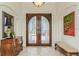 Elegant foyer featuring a double door, arched doorways, and tile flooring at 3 Paradise Ln, Treasure Island, FL 33706
