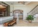 Inviting foyer with tile floors, staircase, and view into the living area and kitchen at 3 Paradise Ln, Treasure Island, FL 33706