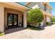 Charming covered entrance with a double door, stone bench, and manicured landscaping at 3 Paradise Ln, Treasure Island, FL 33706