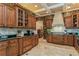 Gourmet kitchen features custom cabinets, granite counters and designer wallpaper at 3 Paradise Ln, Treasure Island, FL 33706