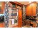 Gourmet kitchen featuring stainless steel appliances, built-in oven, and designer wallpaper at 3 Paradise Ln, Treasure Island, FL 33706