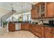 Kitchen with stainless appliances and granite counters; open to the staircase and living room at 3 Paradise Ln, Treasure Island, FL 33706