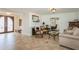 Open living room with tile flooring, and views to the front entrance and office at 3 Paradise Ln, Treasure Island, FL 33706