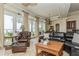 Comfortable living room featuring multiple windows and a leather furniture set at 3 Paradise Ln, Treasure Island, FL 33706