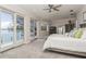 This main bedroom features large windows with waterfront views and neutral colors at 3 Paradise Ln, Treasure Island, FL 33706