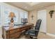 Bright home office features natural light from shuttered windows and a comfortable workspace at 3 Paradise Ln, Treasure Island, FL 33706