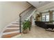 Elegant staircase with wood and iron details leading to the upstairs living area at 3 Paradise Ln, Treasure Island, FL 33706