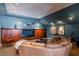 Home theater room features a large sectional sofa, custom cabinetry, and movie-themed decor at 3 Paradise Ln, Treasure Island, FL 33706