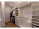 Walk-in closet features custom shelves, drawers, and hanging rods at 3 Paradise Ln, Treasure Island, FL 33706