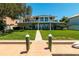 Stunning waterfront view featuring a private dock and lush backyard at 3 Paradise Ln, Treasure Island, FL 33706