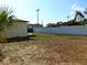 Backyard featuring an open lawn, partial fence, and exterior view of the home at 3002 W Haya St, Tampa, FL 33614