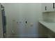 Laundry room with washer/dryer hookups, a countertop, and storage cabinets at 3002 W Haya St, Tampa, FL 33614