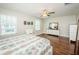 Spacious bedroom features hardwood floors, lots of light, and ceiling fan at 32094 Pop Ash Pl, San Antonio, FL 33576