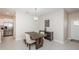 Bright dining area featuring a wooden table set for four, complemented by stainless steel appliances at 32094 Pop Ash Pl, San Antonio, FL 33576