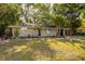 Charming single-story home with mature landscaping and a well-manicured lawn at 3215 Corey Rd, Sarasota, FL 34232