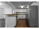 Modern kitchen featuring stainless steel appliances, granite countertops, and white cabinets at 3215 Corey Rd, Sarasota, FL 34232