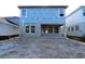 Back exterior of a new build featuring large windows and a patio area, waiting for landscaping to complete the space at 3319 Guanabana Xing, Wesley Chapel, FL 33543