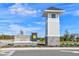 Community entrance with Persimmon Park at Wiregrass Ranch sign and tower at 3319 Guanabana Xing, Wesley Chapel, FL 33543