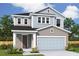 Charming two-story home with attached two-car garage and inviting covered entryway at 3319 Guanabana Xing, Wesley Chapel, FL 33543