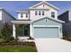 Charming two-story home featuring a two-car garage and beautifully landscaped front yard at 3319 Guanabana Xing, Wesley Chapel, FL 33543