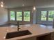 Kitchen featuring bar top with a beautiful view of a lake at 3319 Guanabana Xing, Wesley Chapel, FL 33543