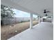 A view of the covered back porch with ceiling fans and a fenced-in backyard at 3329 Roxbury Dr, Holiday, FL 34691