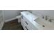 Bathroom vanity with double sinks, a marble countertop, and dark hardware at 3329 Roxbury Dr, Holiday, FL 34691