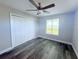 Bedroom with laminate floors, ceiling fan, and a window offering natural light at 3329 Roxbury Dr, Holiday, FL 34691