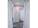 Hallway with laminate floors and interior doors at 3329 Roxbury Dr, Holiday, FL 34691