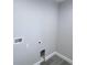A gray-toned laundry room with laminate floors and washer hookups at 3329 Roxbury Dr, Holiday, FL 34691