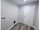 A gray-toned laundry room with laminate floors and washer hookups at 3329 Roxbury Dr, Holiday, FL 34691