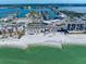 Expansive coastal view featuring pristine beach, vibrant waters, and nearby buildings with waterfront access at 343 Rex Pl # G, Madeira Beach, FL 33708