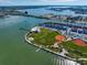 Community aerial view showing residences, baseball field, tennis court, boat docks, waterfront access and park at 343 Rex Pl # G, Madeira Beach, FL 33708