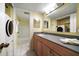 Bathroom featuring a bathtub, showerhead, vanity, mirror, and a washer/dryer at 343 Rex Pl # G, Madeira Beach, FL 33708