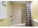 Bathroom featuring a bathtub with showerhead, shower curtain, and a toilet at 343 Rex Pl # G, Madeira Beach, FL 33708