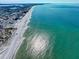 Overhead view of a sun-soaked beach; blue water meets white sand in this vibrant coastal image at 343 Rex Pl # G, Madeira Beach, FL 33708